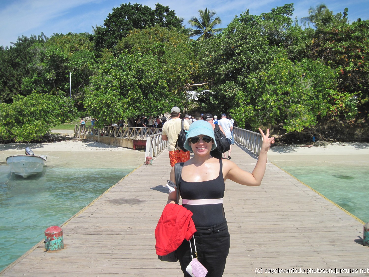 Joann stands on the dock of Cayo Levantado.jpg