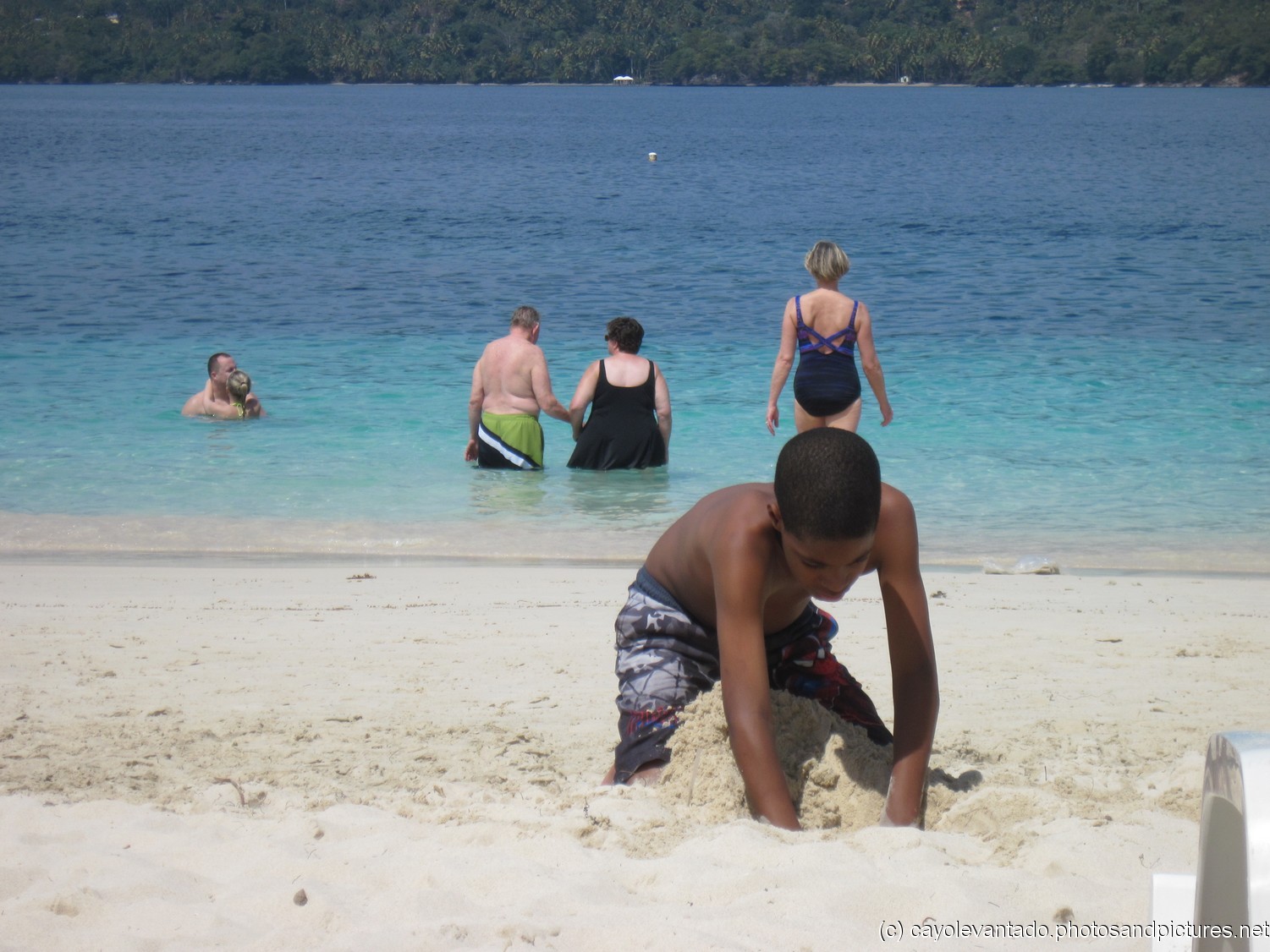 Kid digging a hole at the Cayo Levantado beach.jpg