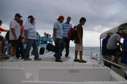 Using tender boat as a bridge to get to another boat leaving Cayo Levantado.jpg