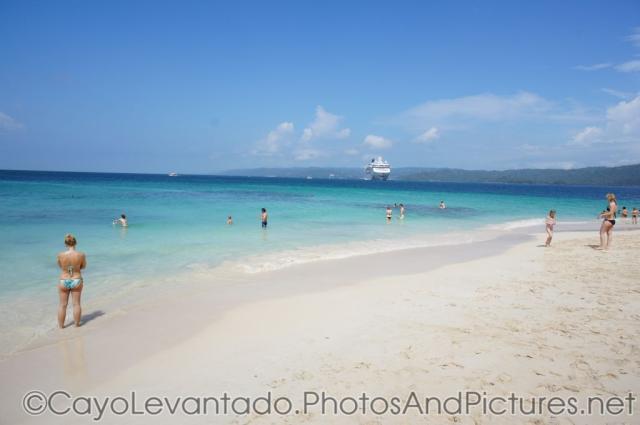 White sand beach with NCL Dawn in the distance at Cayo Levantado.jpg