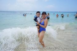 Darwin being held by mommy at Cayo Levantado as a wave comes in.jpg