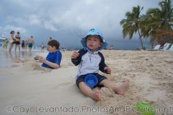 Darwin sits on the beach sand of Cayo Levantado.jpg