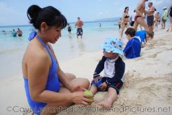 Darwin and mommy sit at the Cayo Levantado beach sand.jpg