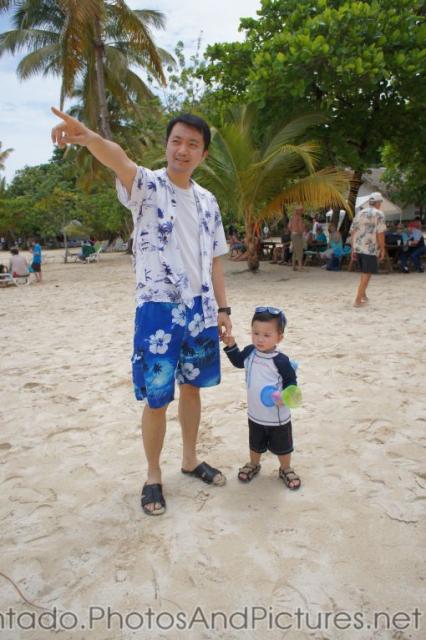 Darwin holds daddy's hand as daddy points at Cayo Levantado.jpg