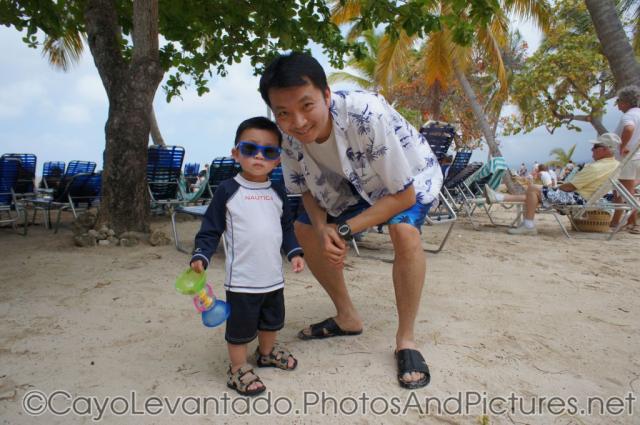 Darwin in sunglasses stand next to daddy at Cayo Levantado.jpg