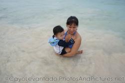 Darwin being held by mommy right above beach waters at Cayo Levantado.jpg
