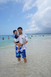 Darwin and daddy at Cayo Levantado with Norwegian Dawn in the distance.jpg