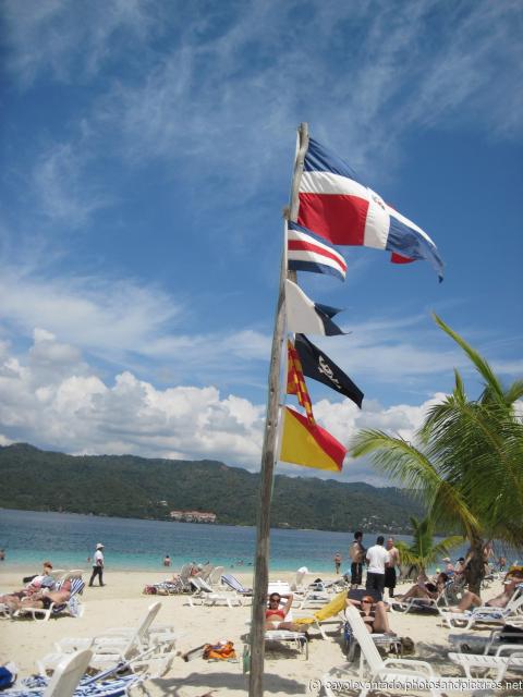 Dominican Republic flag and other flags at Cayo Levantado.jpg